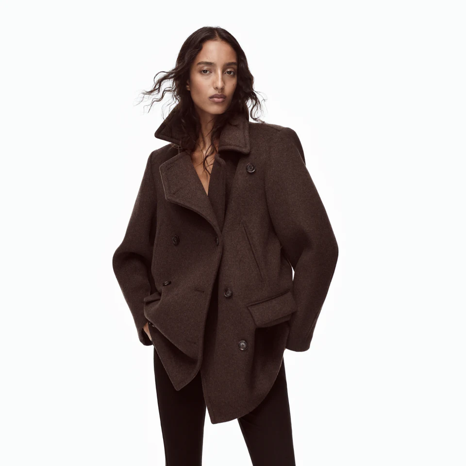 Model wearing a brown oversized coat in Gap’s Victoria Beckham fall collaboration campaign
