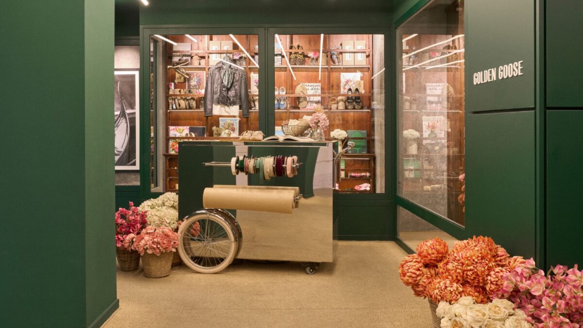 Golden Goose Con Amore gifting area with flowers and wrapping cart