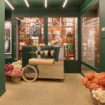 Golden Goose Con Amore gifting area with flowers and wrapping cart