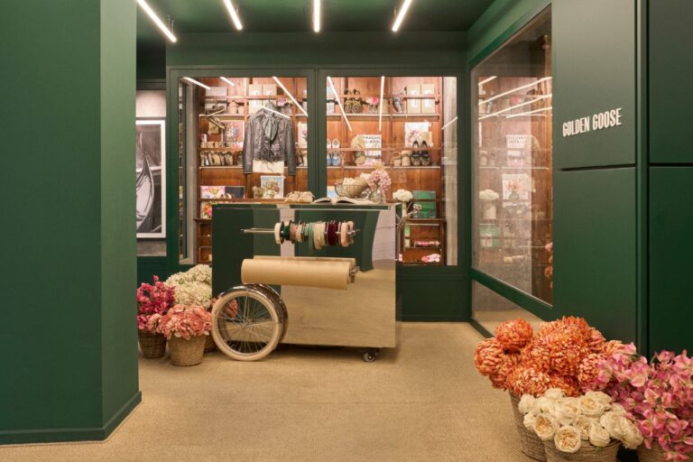 Golden Goose Con Amore gifting area with flowers and wrapping cart