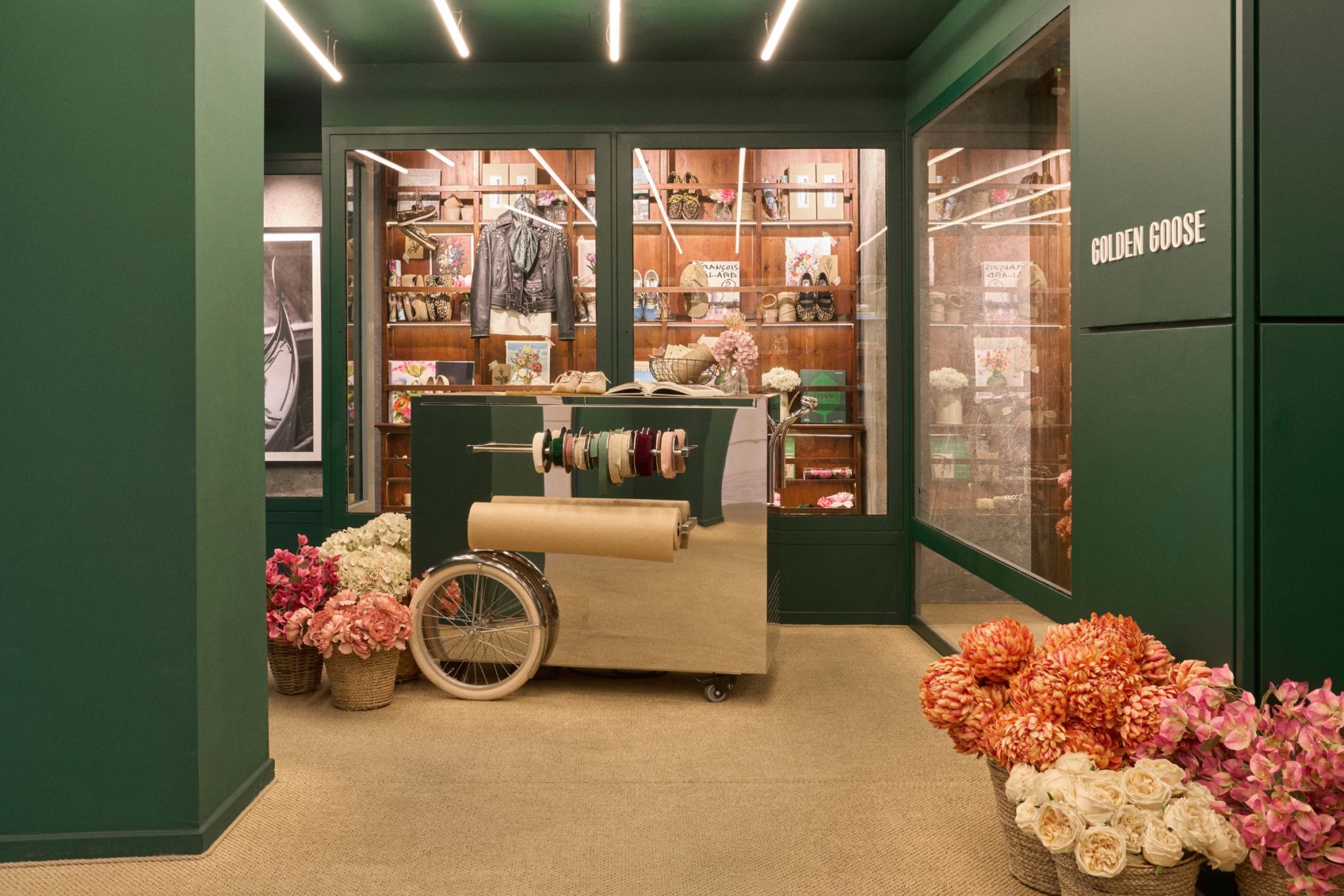 Golden Goose Con Amore gifting area with flowers and wrapping cart