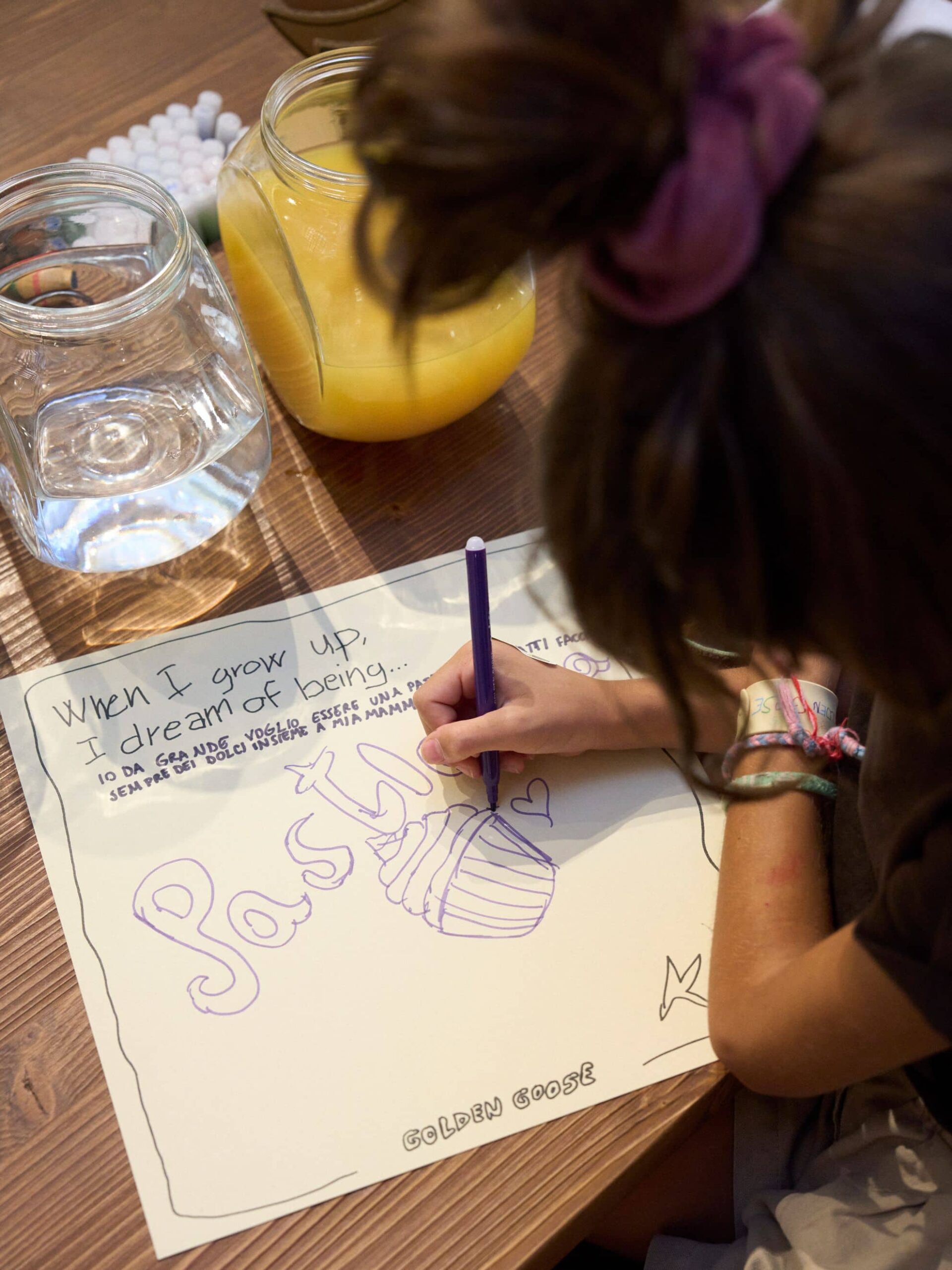 A child drawing during the Golden Goose family celebration activity
