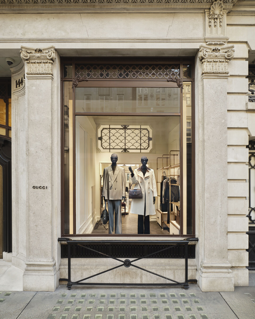 Primavera looks inside a stone-framed Gucci window