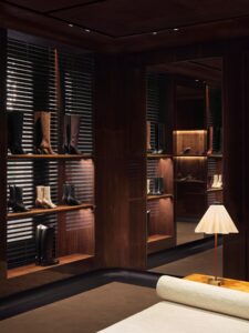 Boot displays and wood paneling inside Gucci’s Avenue Montaigne flagship