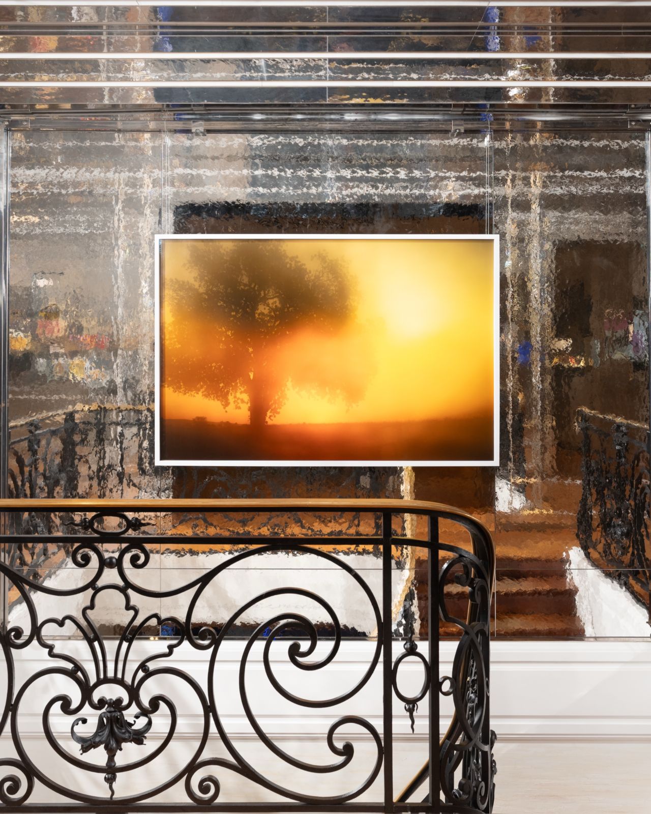Illuminated artwork overlooking the Maison Guerlain staircase