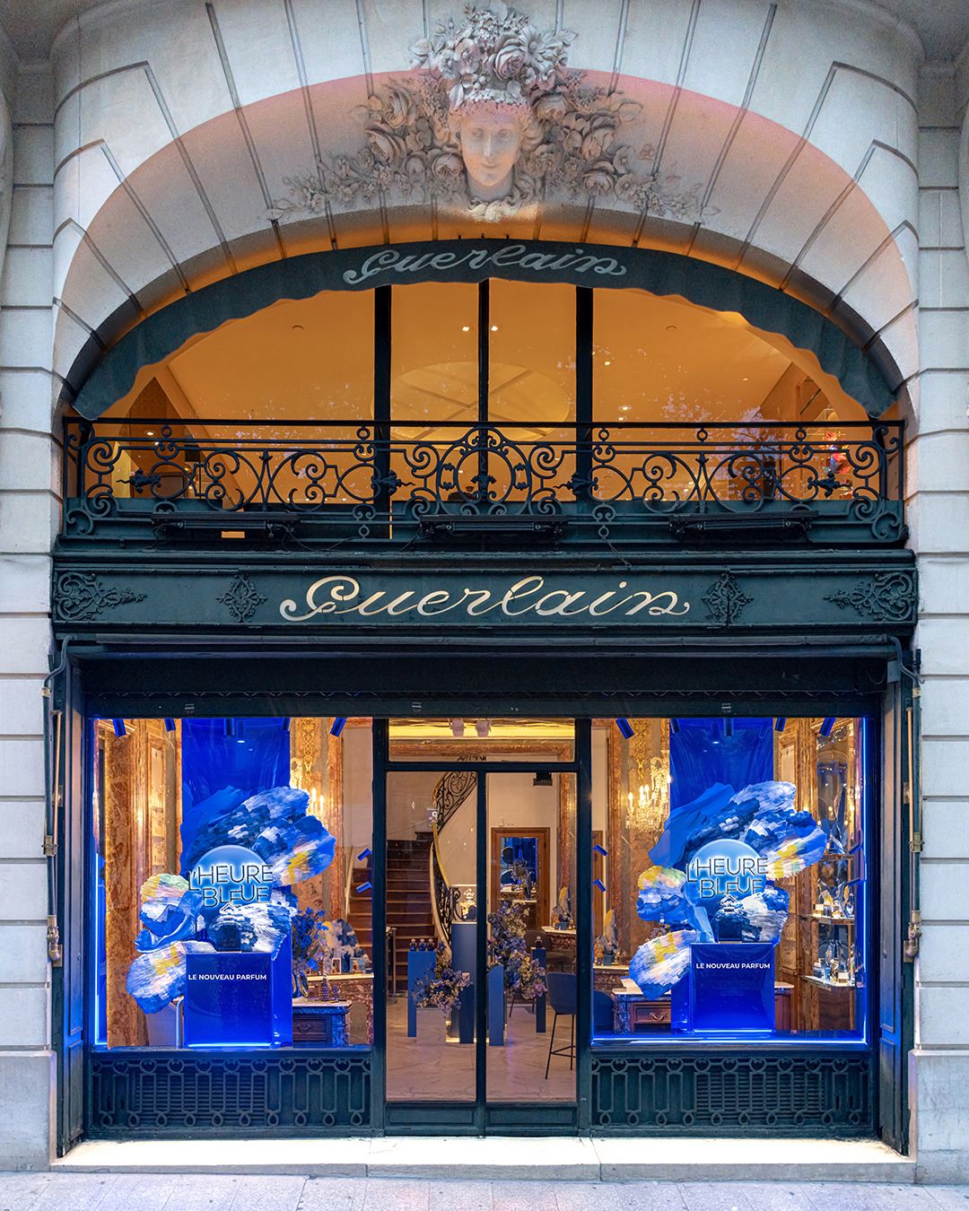 Guerlain's 68 Avenue des Champs-Élysées flagship with blue L’Heure Bleue window displays