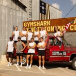 Participants beside Gymshark Conditioning Club branding and a red vehicle in Austin