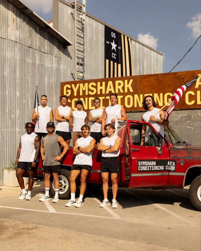 Participants beside Gymshark Conditioning Club branding and a red vehicle in Austin