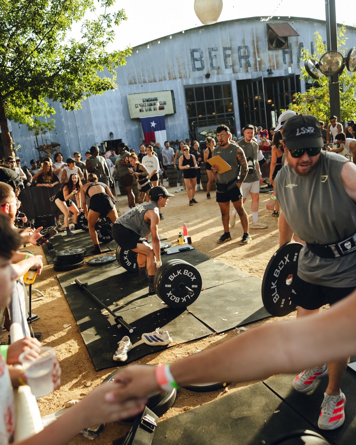 Athlete lifting a loaded barbell at the outdoor activation