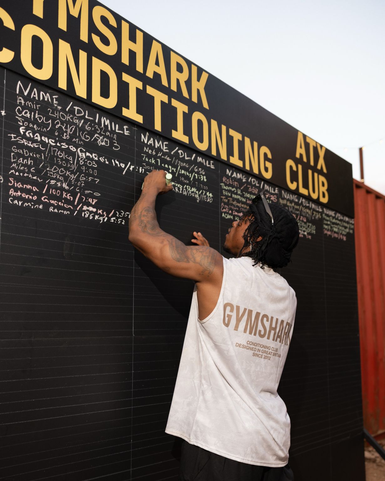 Participant writing on the Gymshark Conditioning Club board