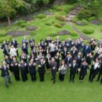 Hermès Japan programme participants gather for a group photograph in a garden
