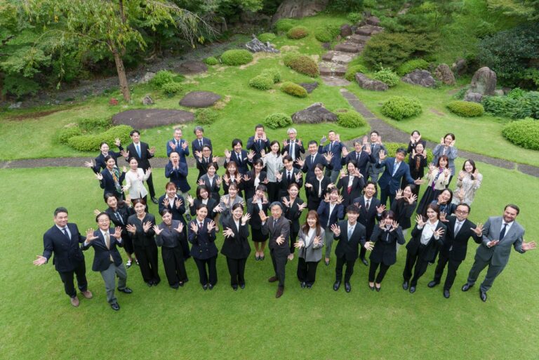 Hermès Japan programme participants gather for a group photograph in a garden