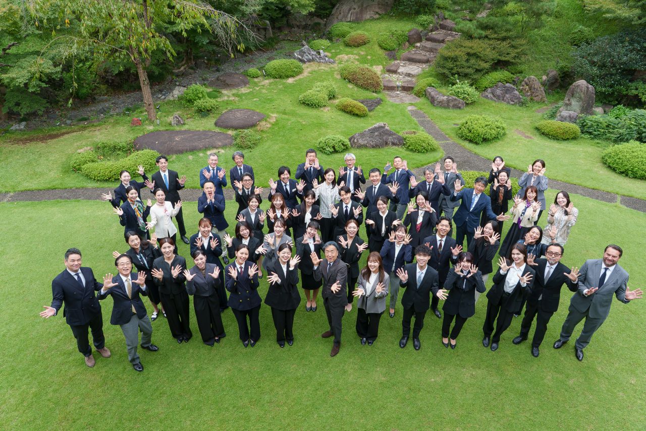 Hermès Japan programme participants gather for a group photograph in a garden