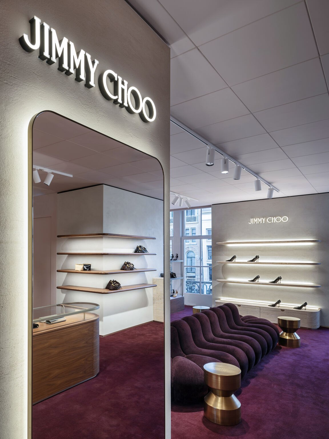 Jimmy Choo mirror and curved NOR11 sofa inside de Bijenkorf Amsterdam