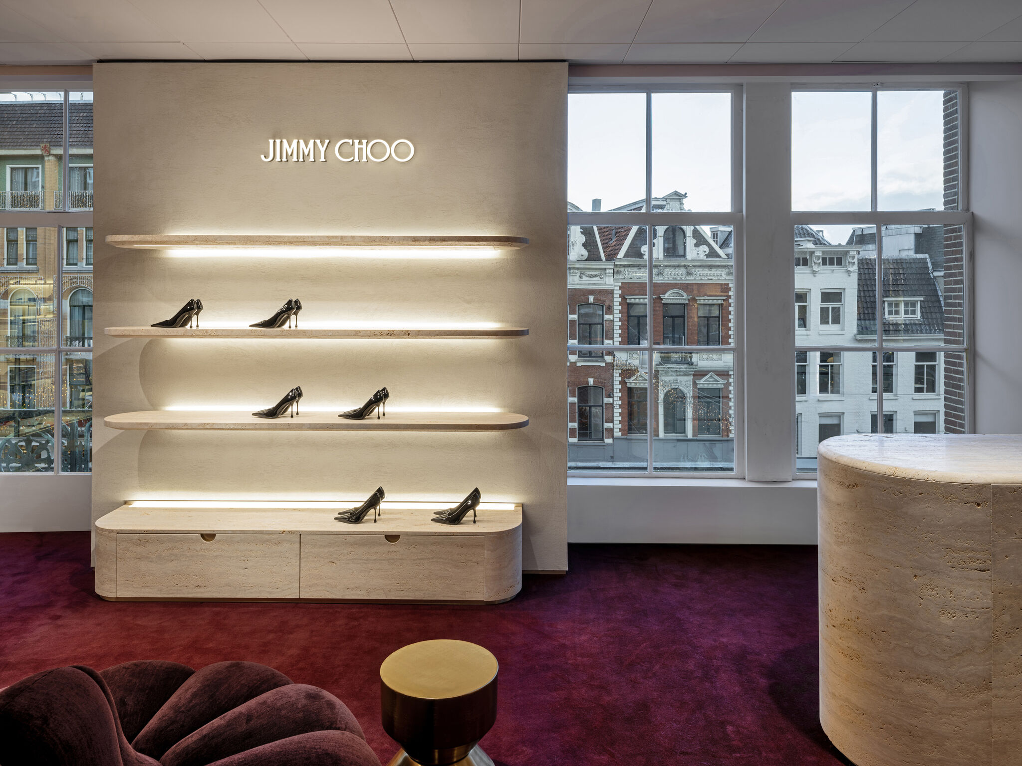 Window-side footwear display and seating at Jimmy Choo de Bijenkorf Amsterdam