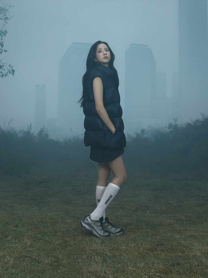 JISOO wears a dark Salomon outfit and trail shoes in the FW26 campaign