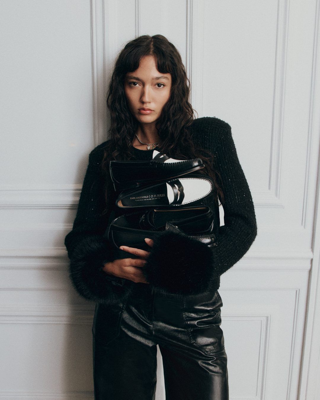 Model holding Karl Lagerfeld and G.H.BASS loafers