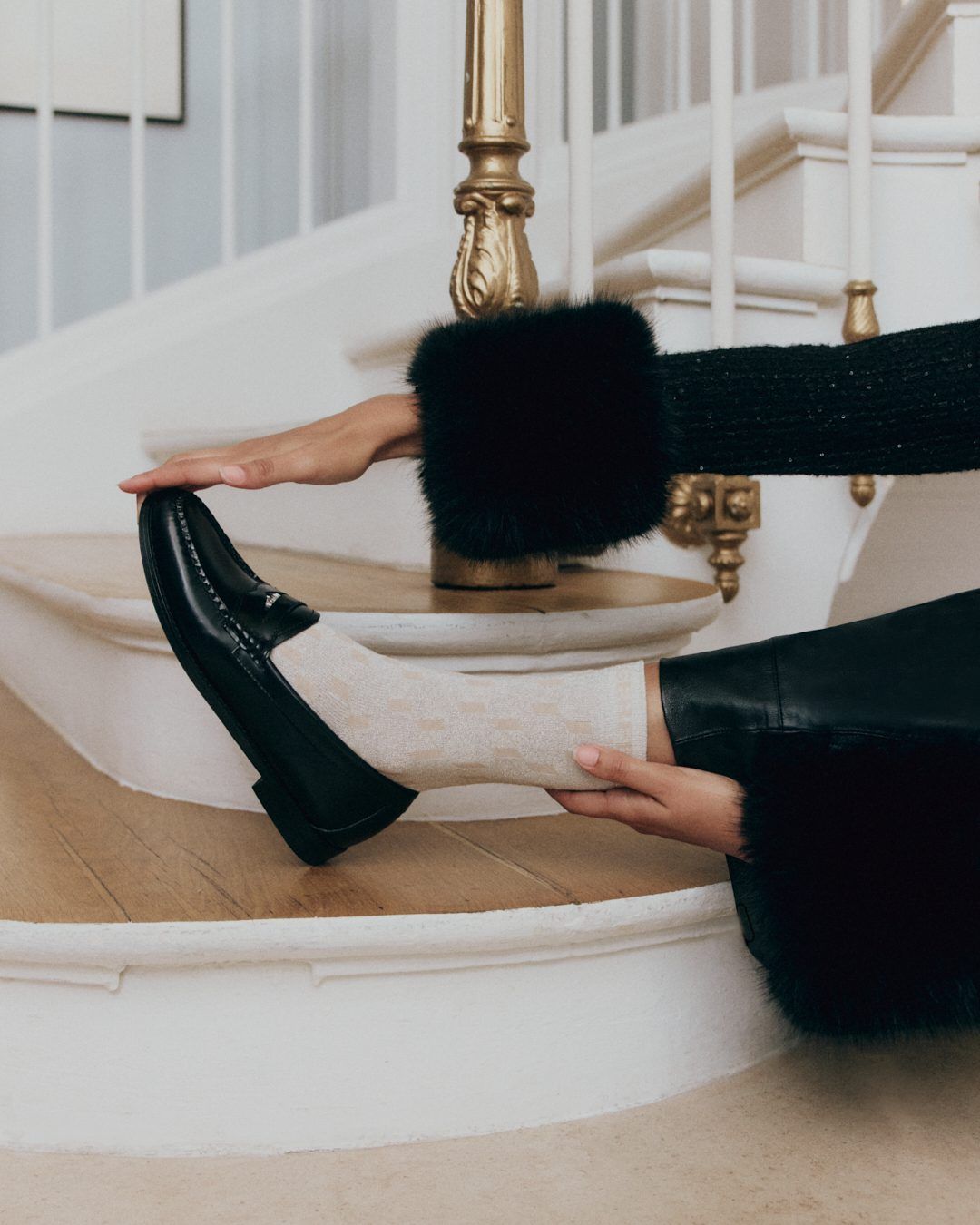 Black loafer styled on a staircase in the collaboration campaign