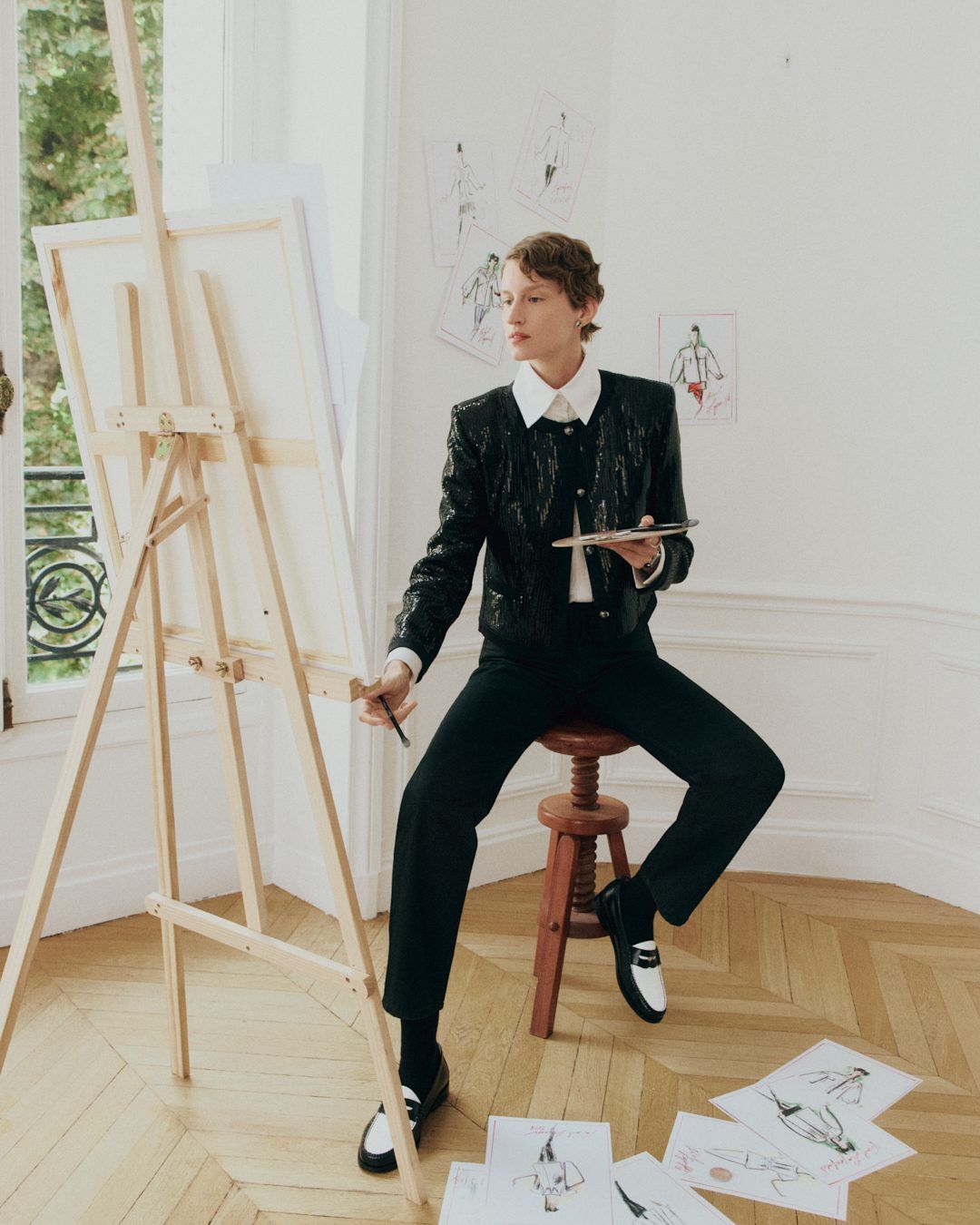 Artist character wearing black-and-white Weejuns loafers