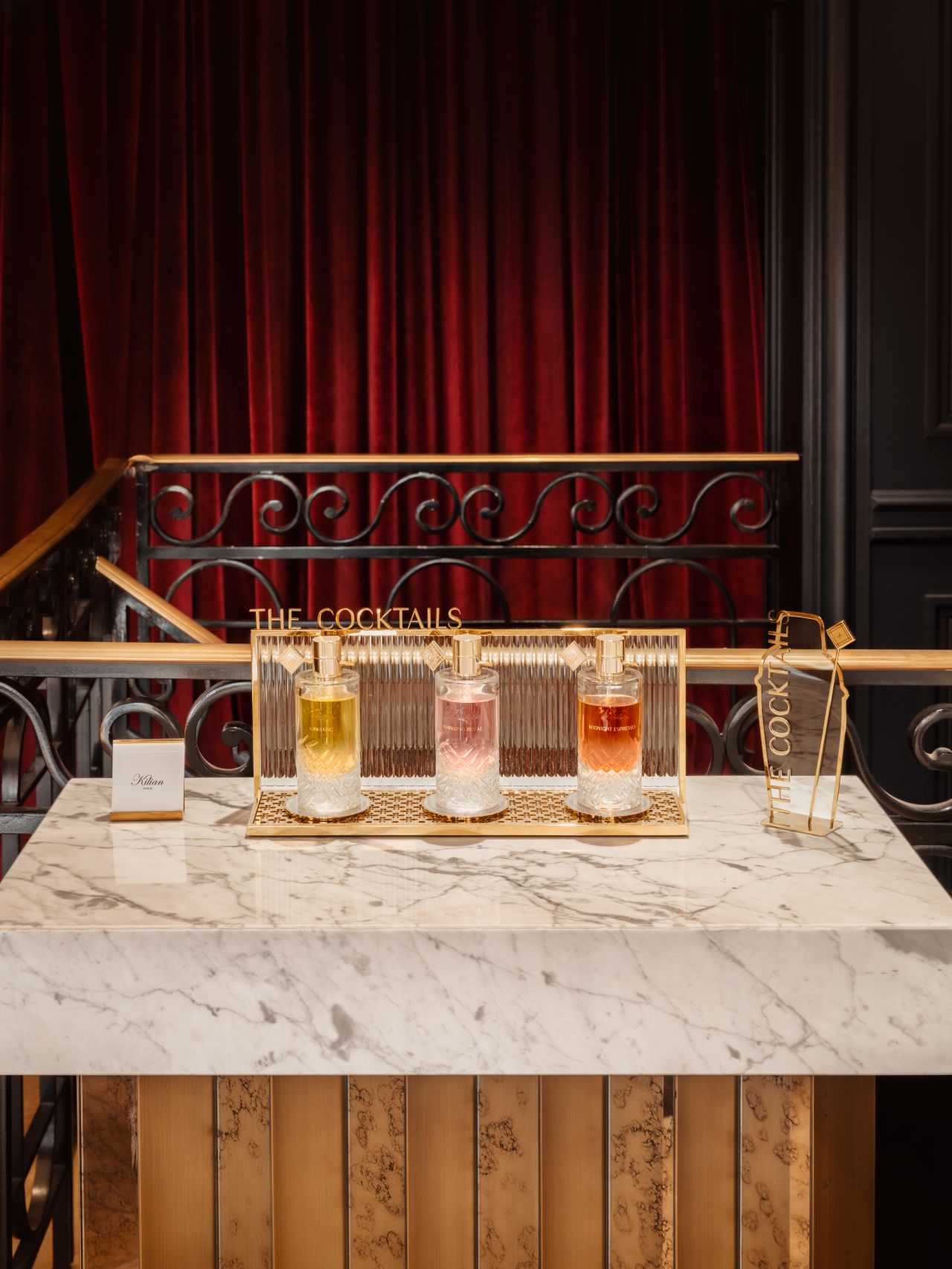 Kilian fragrance bottles arranged on a marble-topped counter