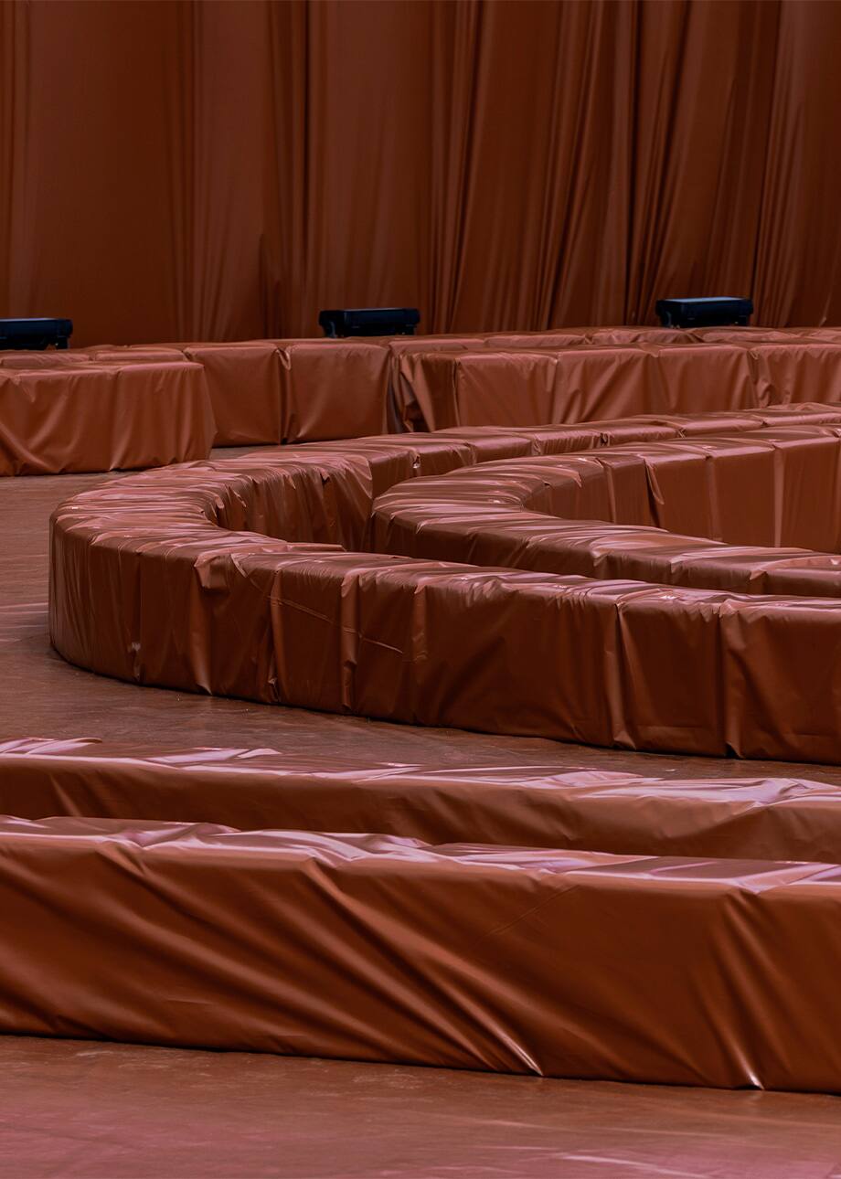 Rust-colored seating at Lacoste’s Shanghai runway venue