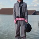 Gray tailoring look beside the water at Lacoste’s Shanghai presentation