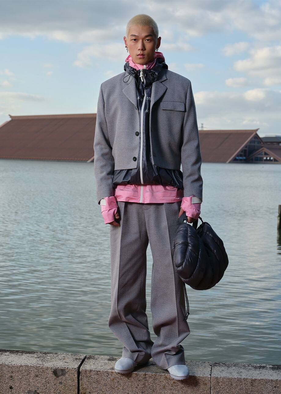 Gray tailoring look beside the water at Lacoste’s Shanghai presentation