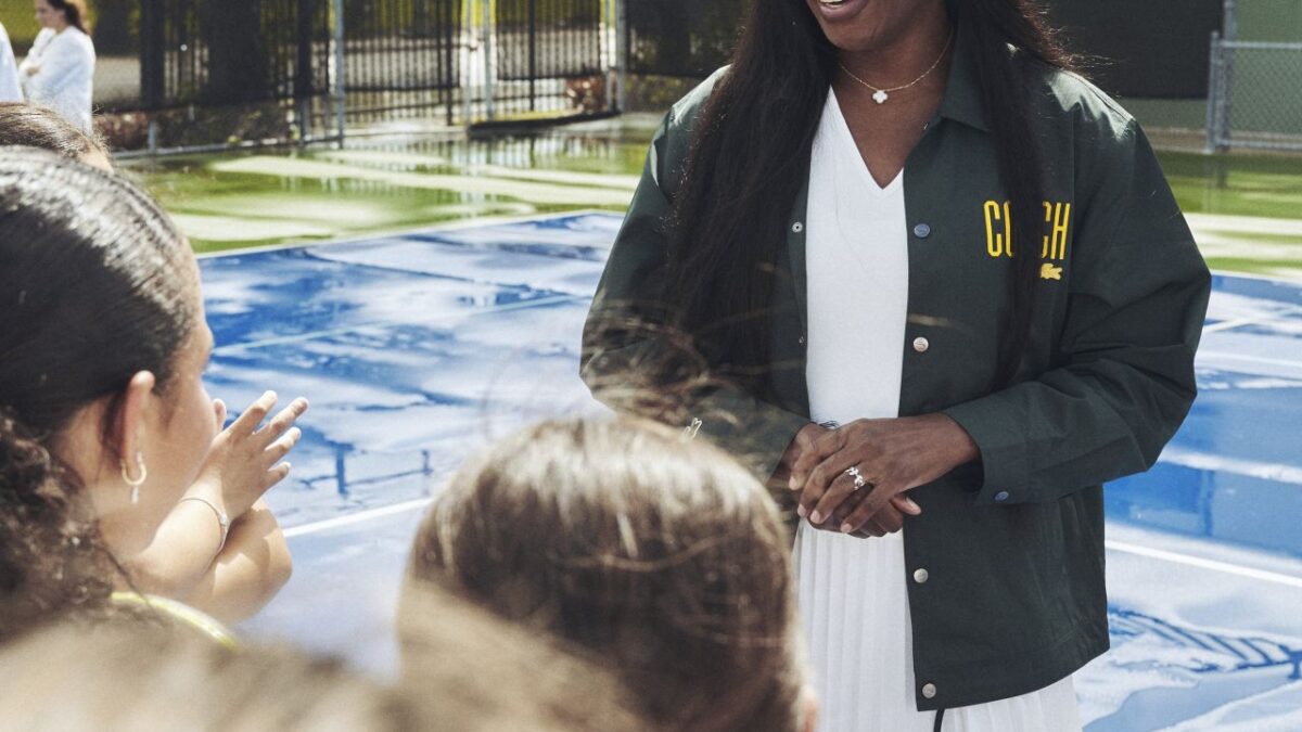 Venus Williams speaking with young tennis participants