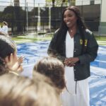 Venus Williams speaking with young tennis participants
