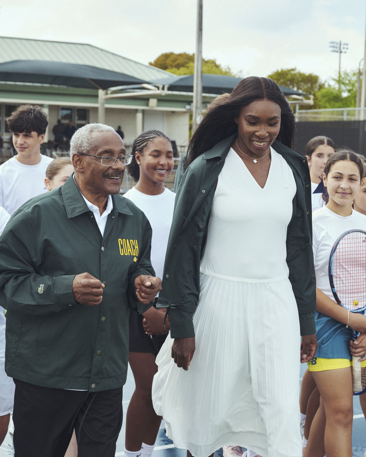 Venus Williams with a coach and young tennis players