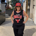 Laura Geller wearing a Chicago Bulls cap and jersey outdoors.