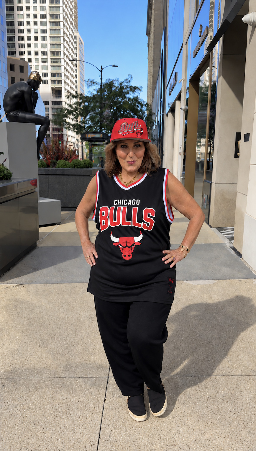 Laura Geller wearing a Chicago Bulls cap and jersey outdoors.