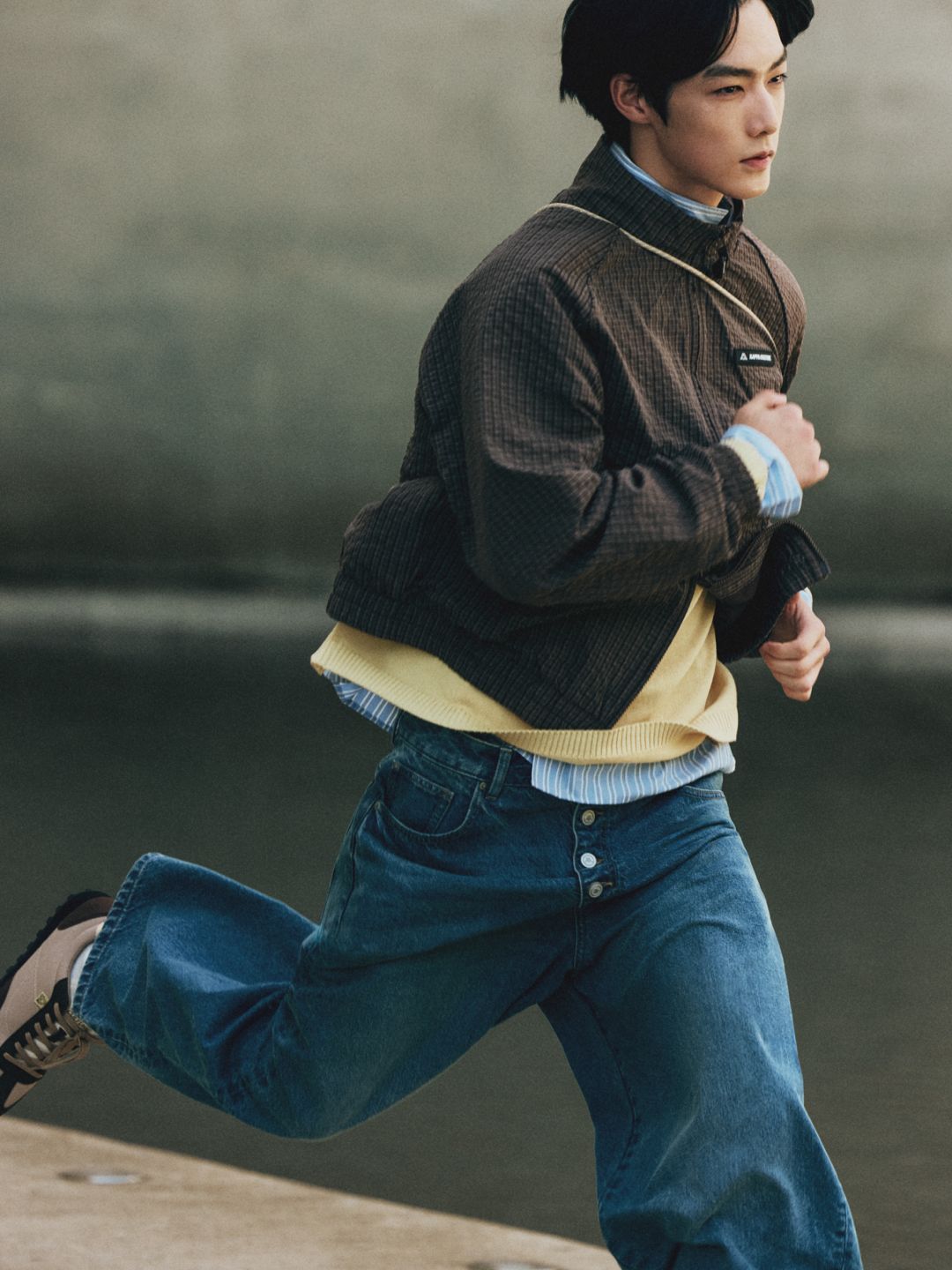 Model moving in Kappa Culture zip jacket and jeans
