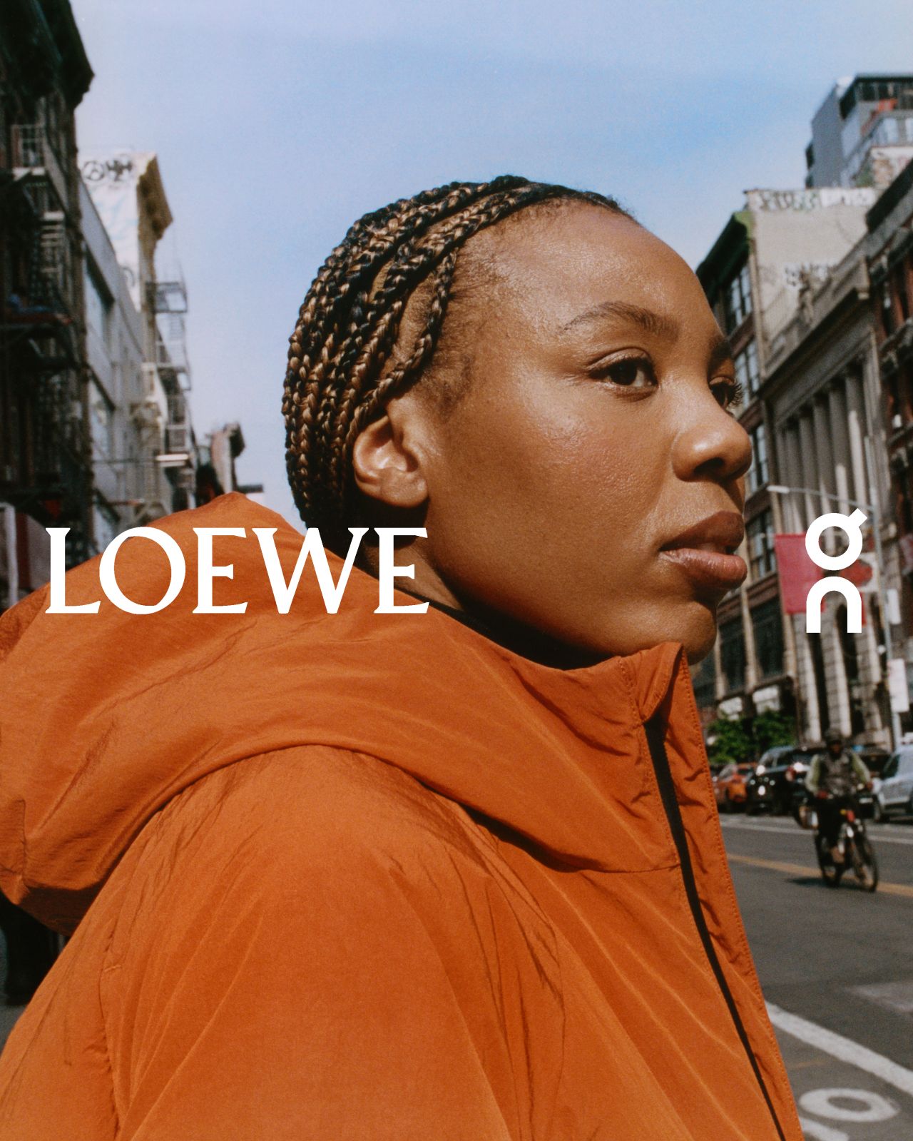 Martine Syms wearing orange outerwear in the LOEWE and On campaign