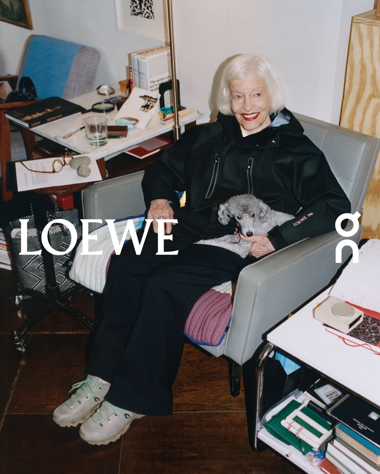 Joan Jonas seated in her studio wearing the LOEWE and On collection