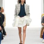LOEWE Spring/Summer 2027 runway look 1 with plaid tailoring and a sculpted white skirt