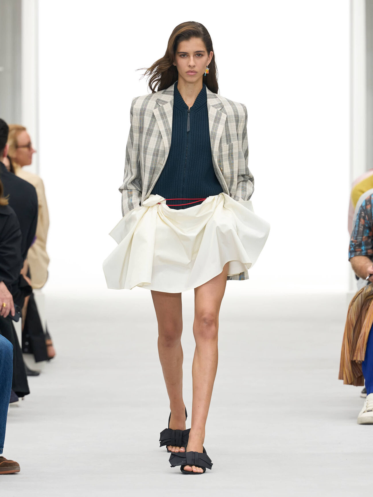 LOEWE Spring/Summer 2027 runway look 1 with plaid tailoring and a sculpted white skirt