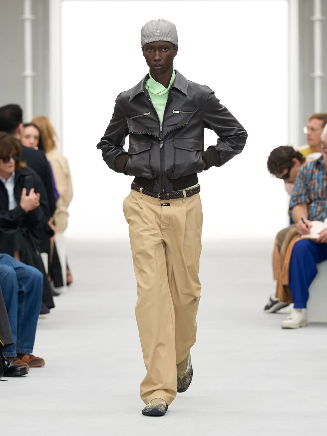 LOEWE Spring/Summer 2027 runway look 6 pairing leather outerwear with khaki trousers