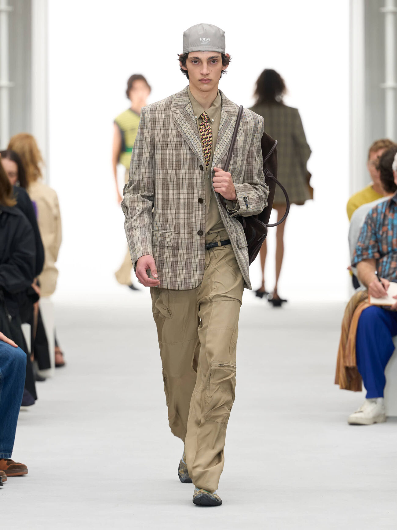 LOEWE Spring/Summer 2027 runway look 12 with plaid tailoring, cargo trousers and a shoulder bag