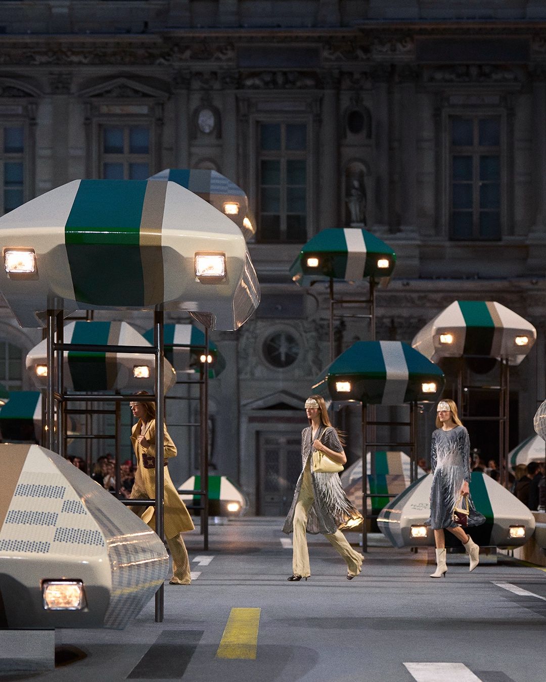 Louis Vuitton Spring/Summer 2027 models move through the Louvre runway scenography