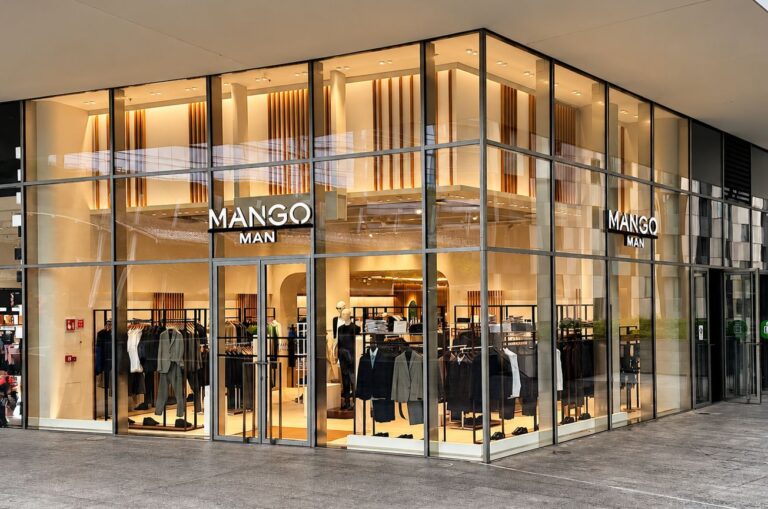 Glass-fronted Mango Man store at Porta Nuova in Milan, with menswear visible inside