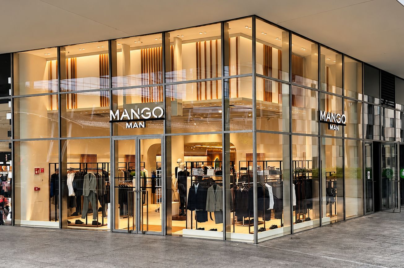 Glass-fronted Mango Man store at Porta Nuova in Milan, with menswear visible inside