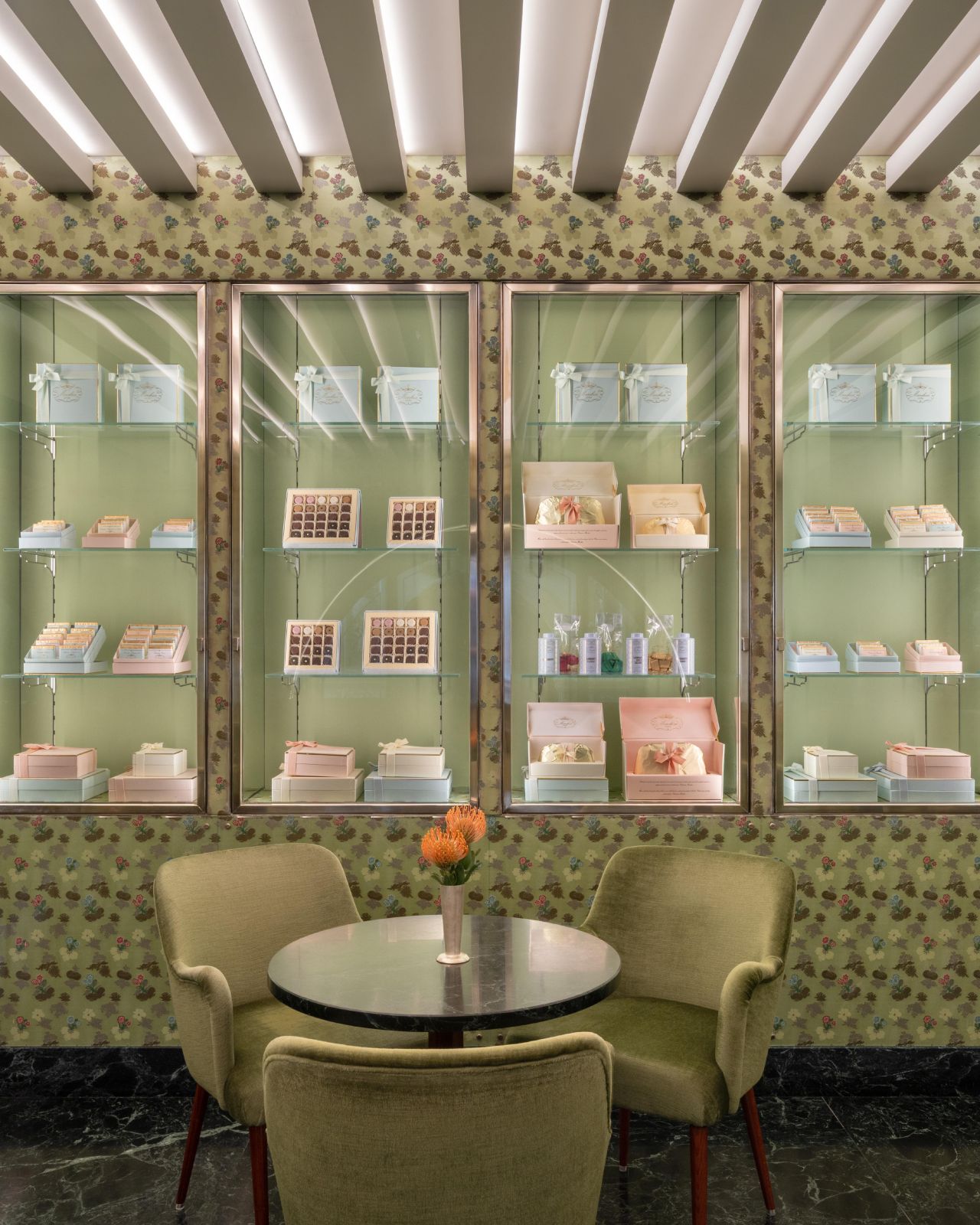 Green seating and display cabinets at Marchesi 1824