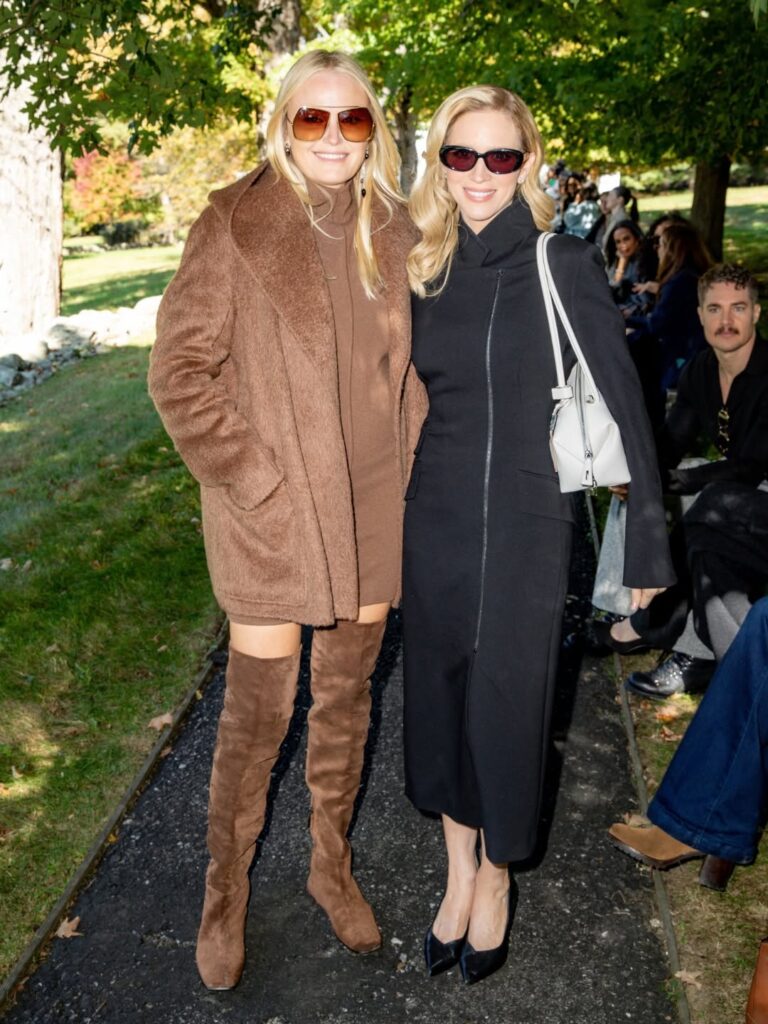 Two guests wearing coats at the Max Mara event on the Glass House grounds