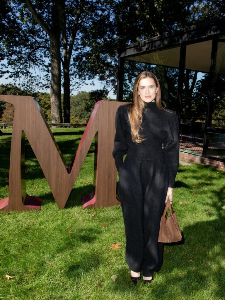 Guest dressed in black beside a Max Mara installation at The Glass House