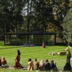 Model walking outdoors near The Glass House during the Max Mara Fall/Winter 2026 presentation
