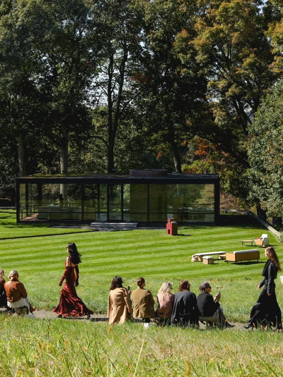 Model walking outdoors near The Glass House during the Max Mara Fall/Winter 2026 presentation