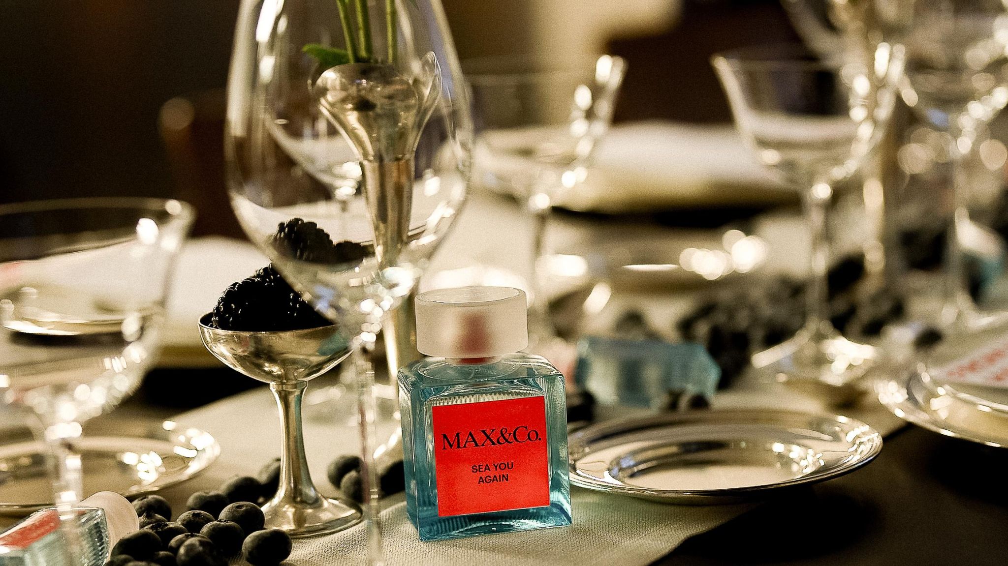 MAX&Co. Sea You Again fragrance bottle on the event table