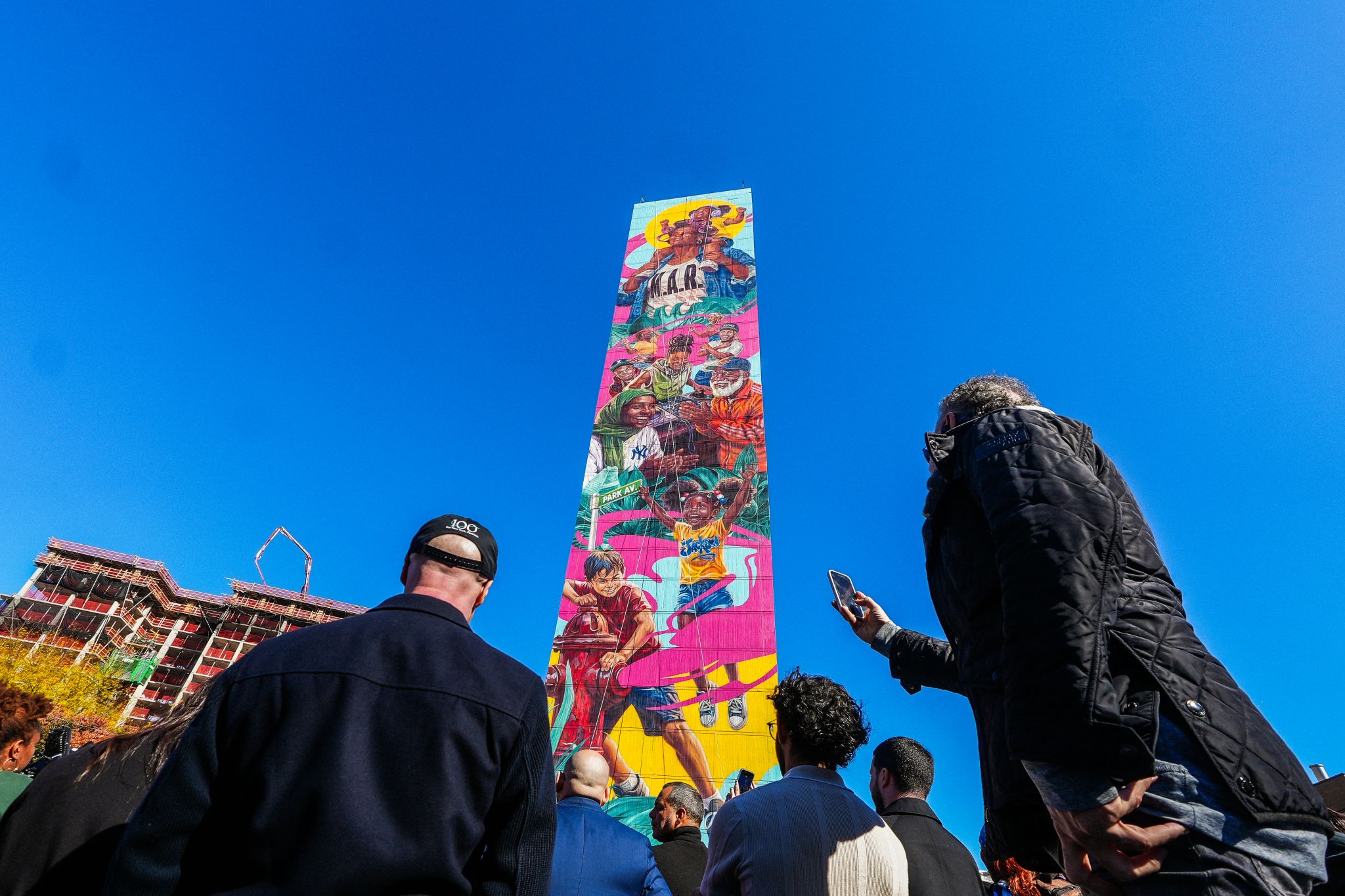 Residents viewing the completed Morrisania Air Rights mural