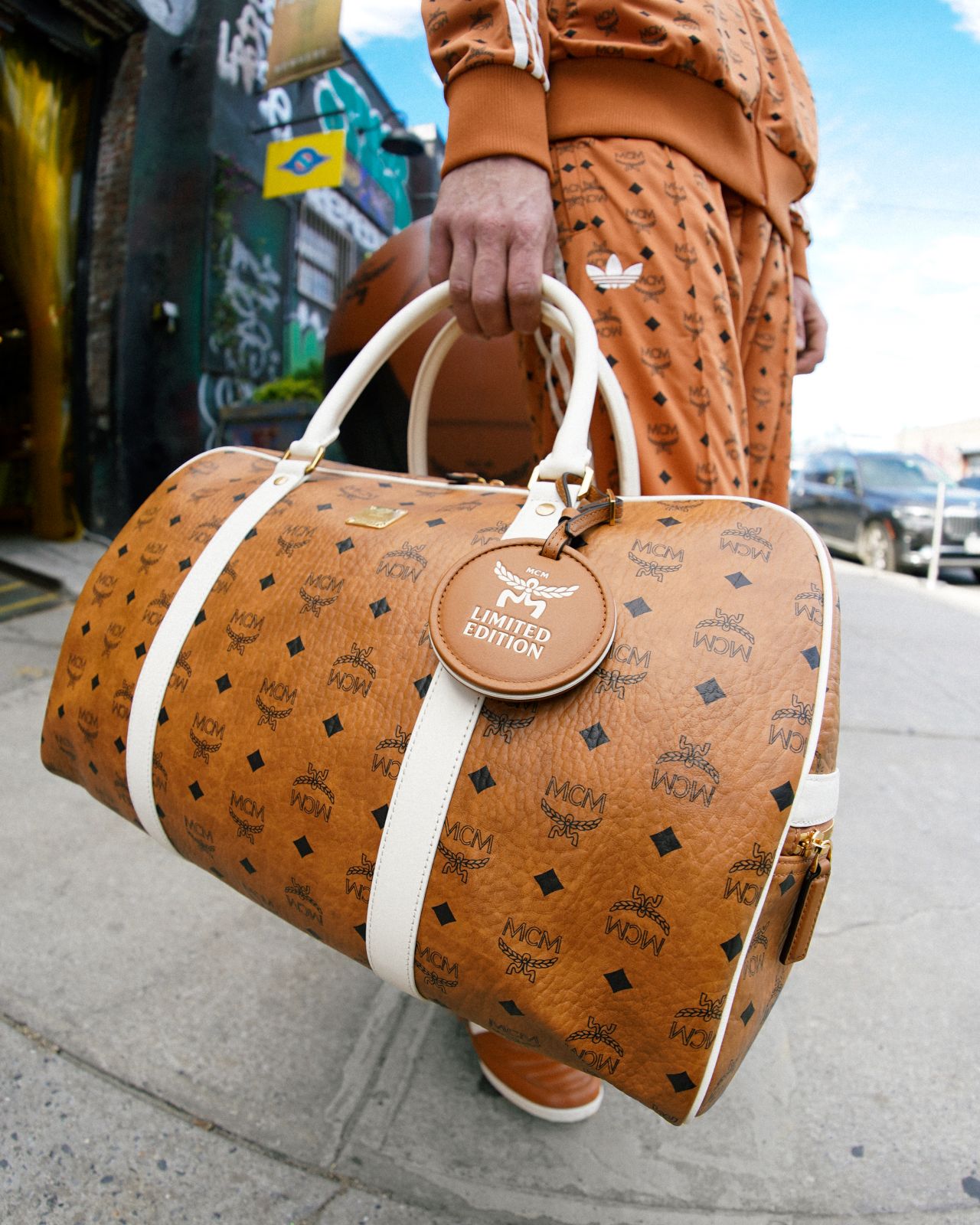 MCM cognac-patterned travel bag at the Brooklyn activation